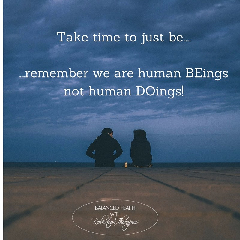 Image of two people sitting on the shoreline - 'take time to just be...remember we are human BEings not human Doings!'