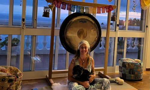 Photograph of Sylvia Shiva with her gong one of your hosts for the 2024 retreat in Madeira